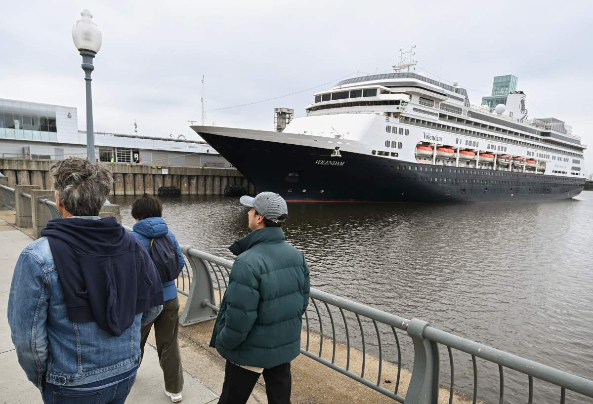 People walk by the Volendam cruise ship in the Port of Montreal, Saturday, May 4, 2024. The cruise ship is the first to arrive in the port this year and housed 1,500 Ukrainian refugees for several months in 2022.