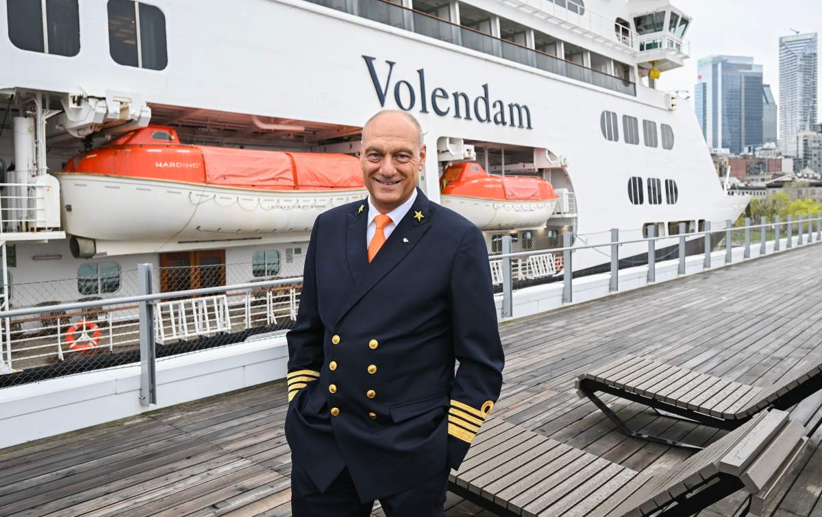 Rens Van Eerten, captain of the Volendam cruise ship, poses alongside the ship in the Port of Montreal, Saturday, May 4, 2024. The cruise ship is the first to arrive in the port this year and housed 1,500 Ukrainian refugees for several months in 2022.