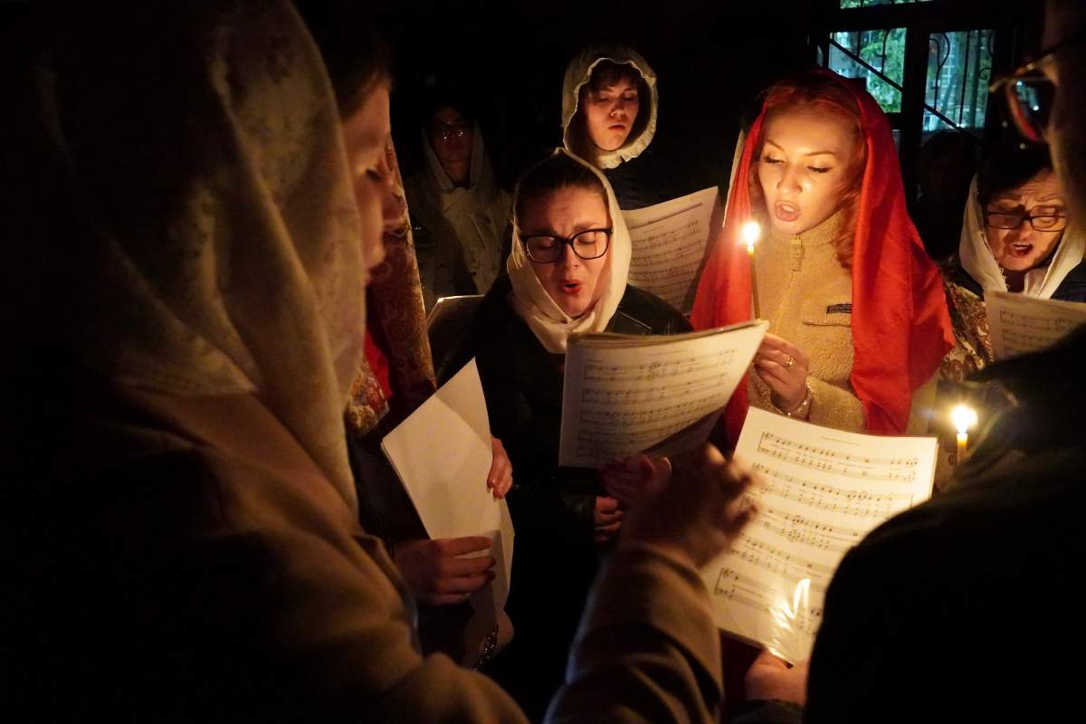 A church choir attend an Orthodox Easter midnight service in the Church of the Holy Prince Alexander Nevsky in Mariupol, Ukraine, late Saturday, May 4, 2024. Eastern Orthodox churches observe the ancient Julian calendar and this year celebrate Orthodox Easter on May 5.