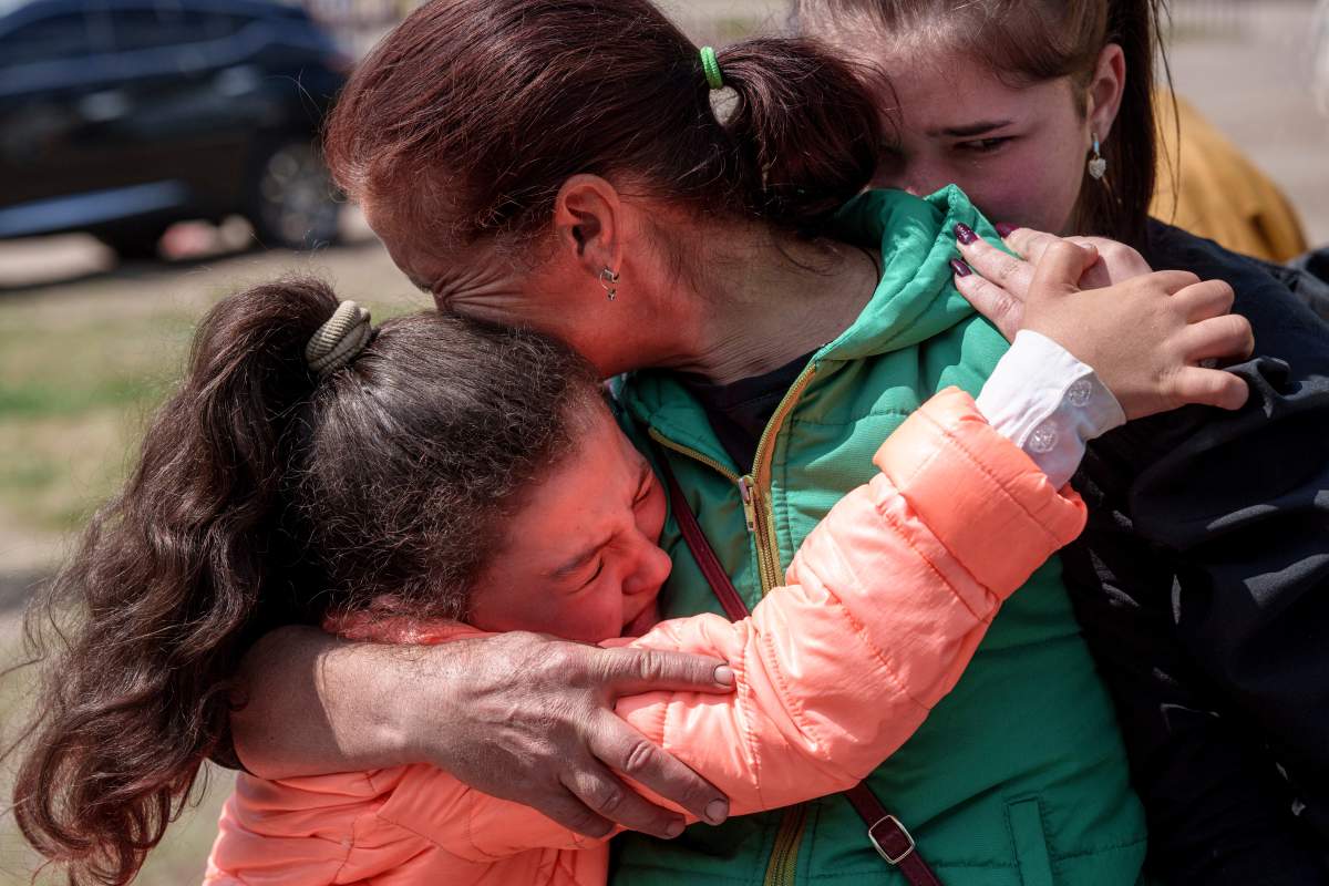 Khrystyna Pyimak, 11, hugs her mother Oksana Velychko, 42, after evacuation from Vovchansk, Ukraine, Sunday, May 12, 2024.