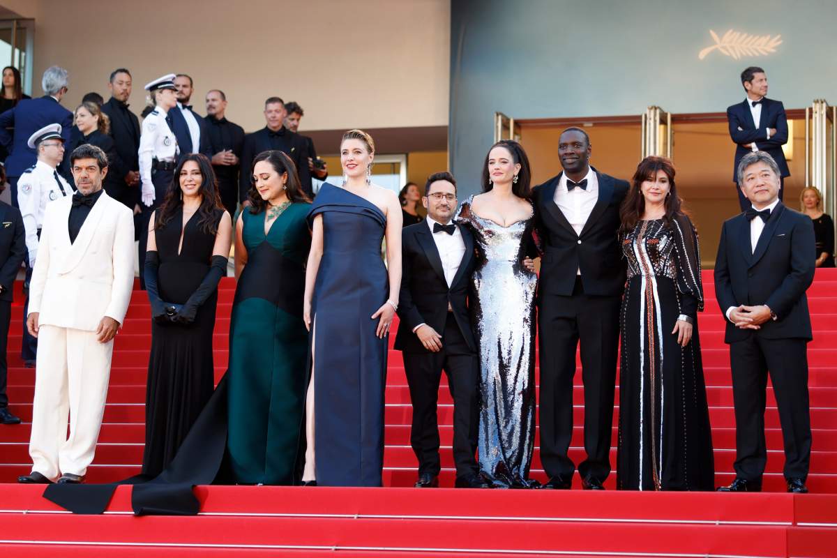 Jury president Greta Gerwig, fourth from left, poses with jury members Pierfrancesco Favino, from left, Nadine Labaki, Lily Gladstone, J. A. Bayona, Eva Green, Omar Sy, Ebru Ceylan, and Kore-eda Hirokazu upon arrival at the awards ceremony during the 77th international film festival, Cannes, southern France, Saturday, May 25, 2024.