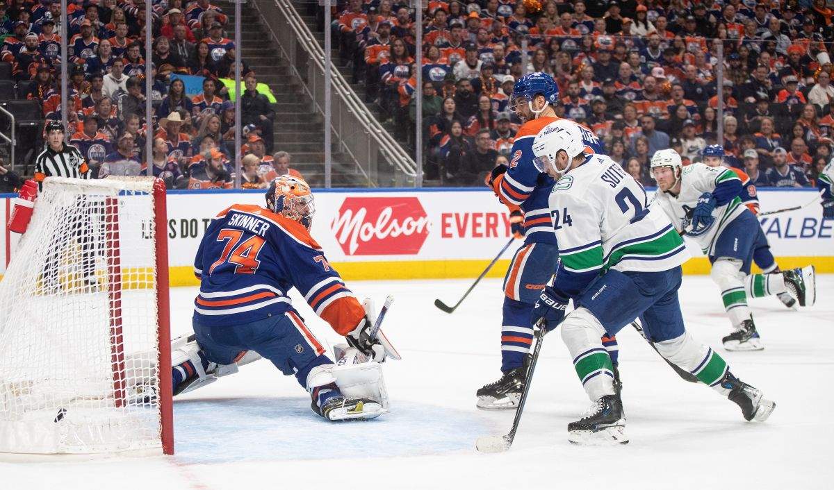 Vancouver Canucks' Pius Suter (24) watches the puck go in the net past Edmonton Oilers goalie Stuart Skinner (74) during first period second-round NHL playoff action in Edmonton on Sunday May 12, 2024.