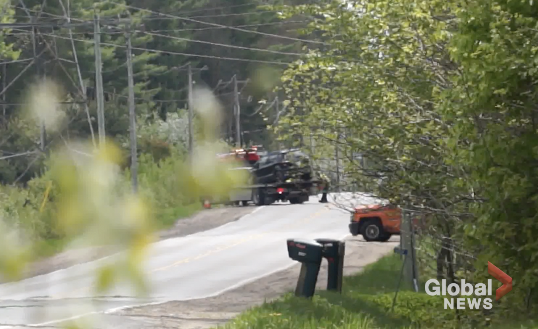 A tow truck driver removes a vehicle involved in a collision with an OPP cruiser on County Road 21 in Minden Hills, Ont., on May 19, 2024.