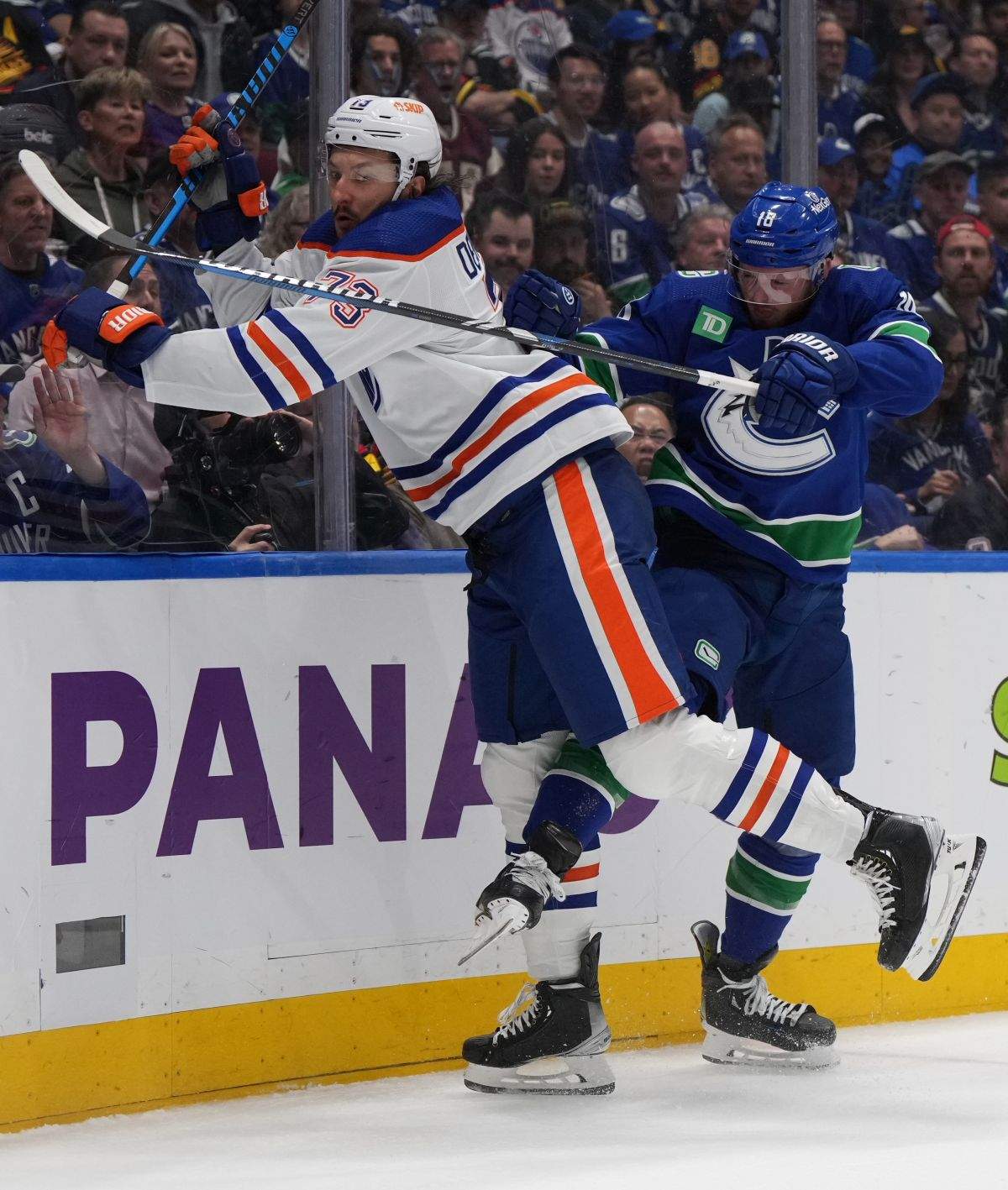 Edmonton Oilers defenceman Vincent Desharnais (73) and Vancouver Canucks centre Sam Lafferty (18) battle along the boards during the first period in Game 7 of an NHL hockey Stanley Cup second-round playoff series in Vancouver on Monday, May 20, 2024.