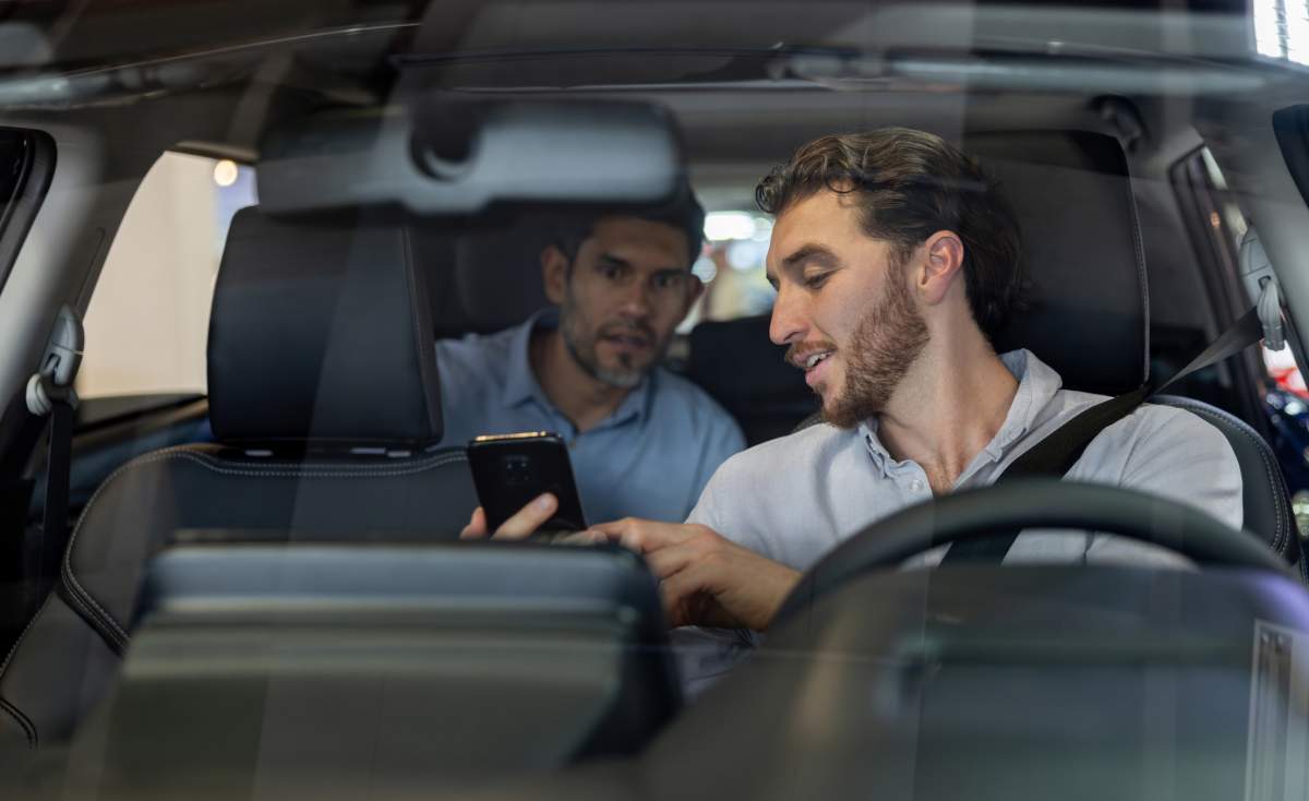 Taxi driver showing his phone after finiding out he has been Fired in Ontario for taking on a side gig