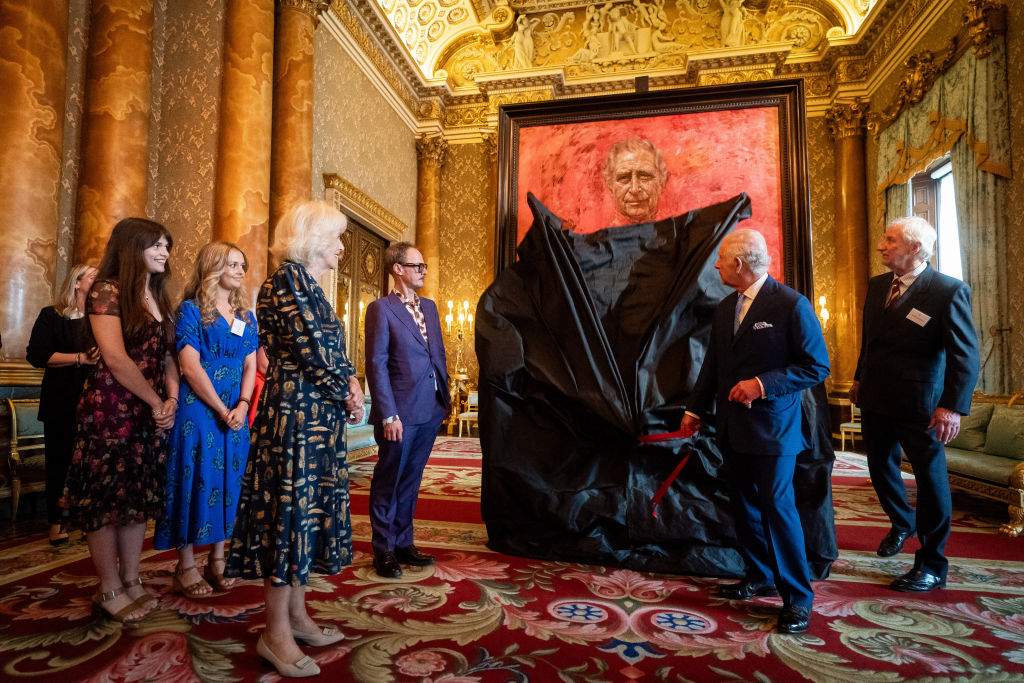 Britain's Queen Camilla watches as Britain's King Charles III unveils an official portrait of himself, by artist artist Jonathan Yeo, depicting the King wearing the uniform of the Welsh Guards, of which he was made Regimental Colonel in 1975.