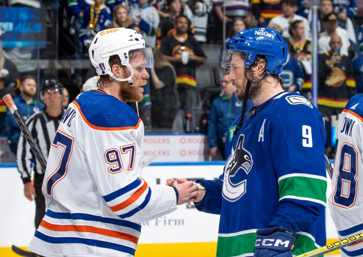 J.T. Miller #9 of the Vancouver Canucks and Connor McDavid #97 of the Edmonton Oilers shake hands after Game Seven of the Second Round of the 2024 Stanley Cup Playoffs at Rogers Arena on May 20, 2024 in Vancouver, British Columbia, Canada. Edmonton won 3-2
