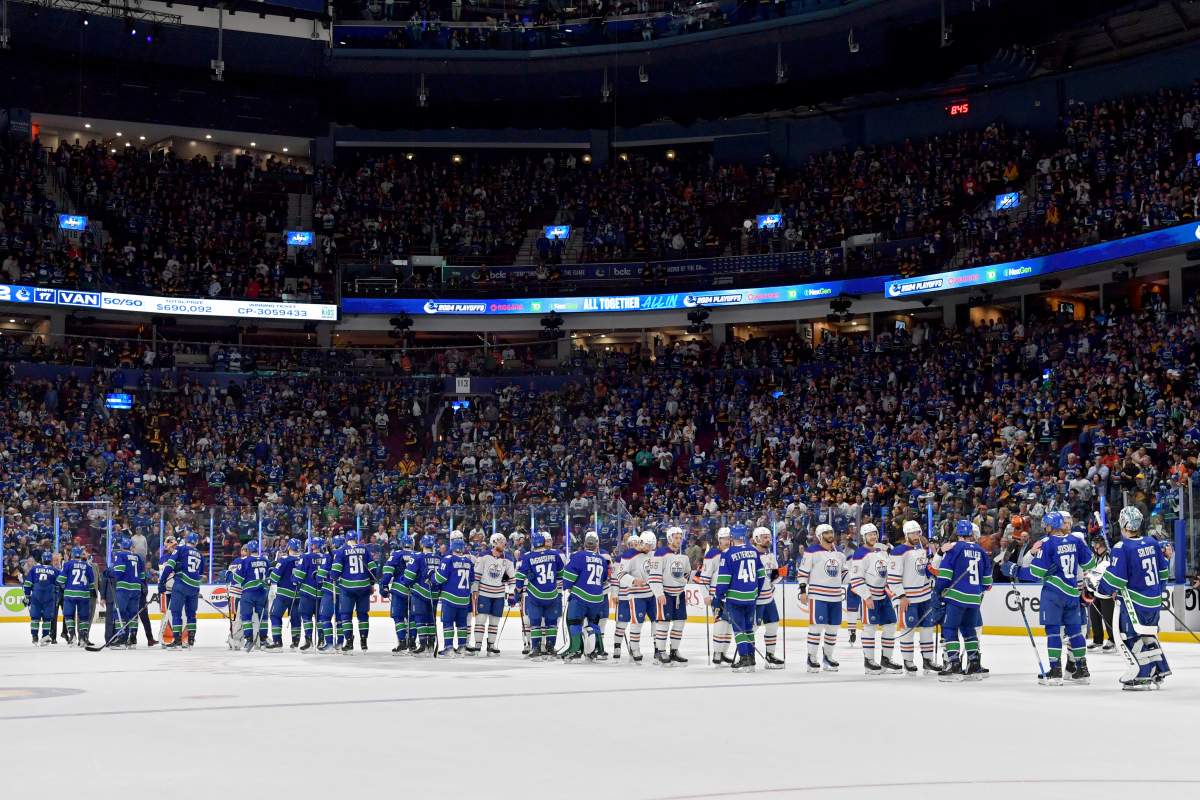 The Edmonton Oilers and The Vancouver Canucks shake hands after Game Seven of the Second Round of the 2024 Stanley Cup Playoffs at Rogers Arena on May 20, 2024 in Vancouver, British Columbia.