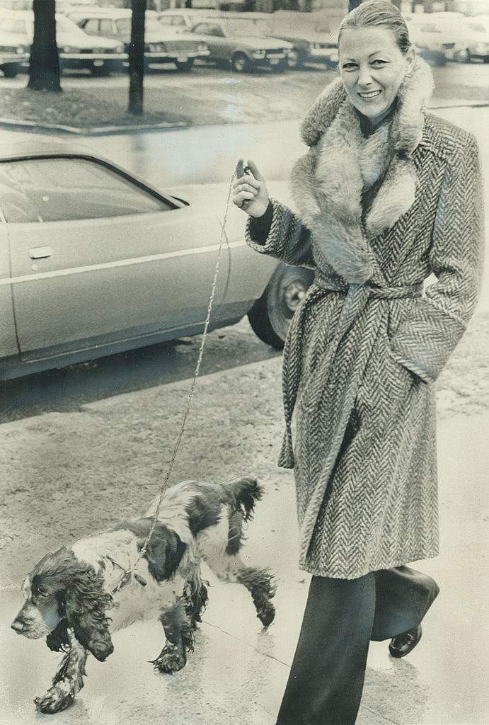 Marina Hundt walks Peter Demeter's dog near the courthouse.