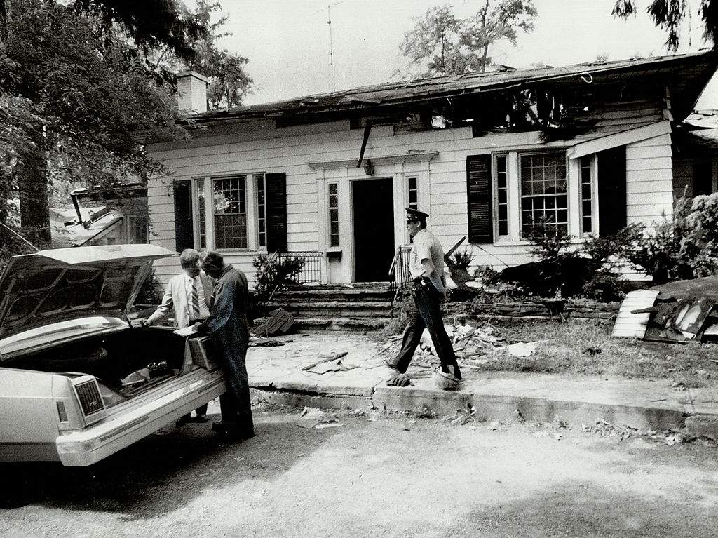 Police and investigators probe the firegutted home of Peter Demeter.