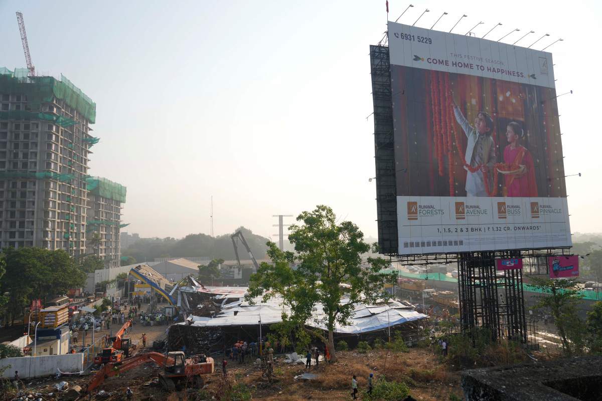 Rescuers search under a large billboard that collapsed Monday evening following heavy rain and thundershowers at Ghatkopar, a suburb of Mumbai, India, Tuesday, May 14, 2024. More than a dozen people were killed and dozens more were injured in the accident.
