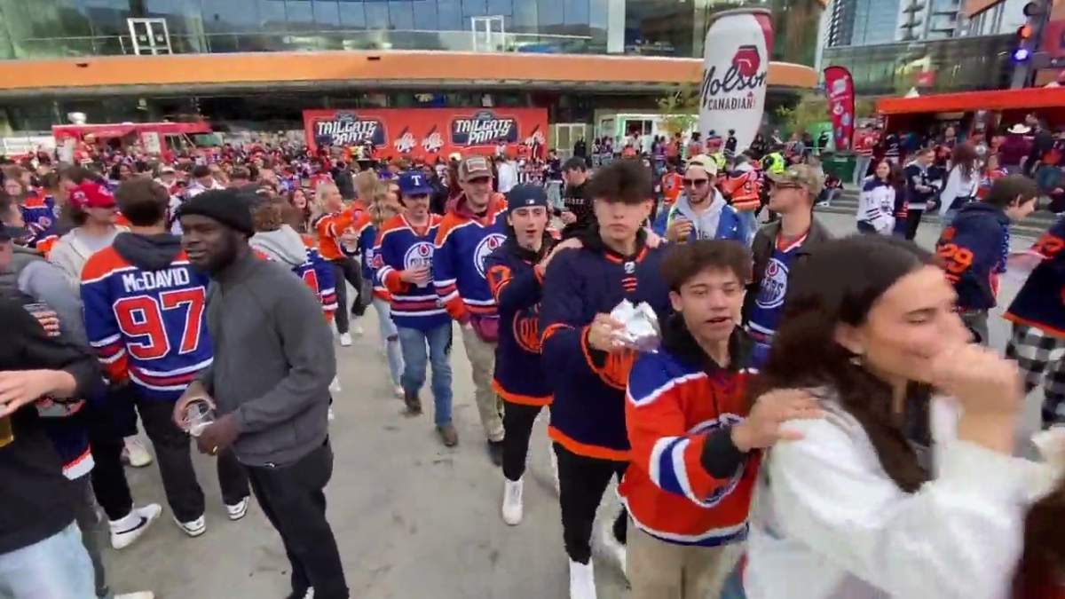 Edmonton Oilers fans forming a conga line at the Ice District Plaza on Thursday, May 24, 2024.
