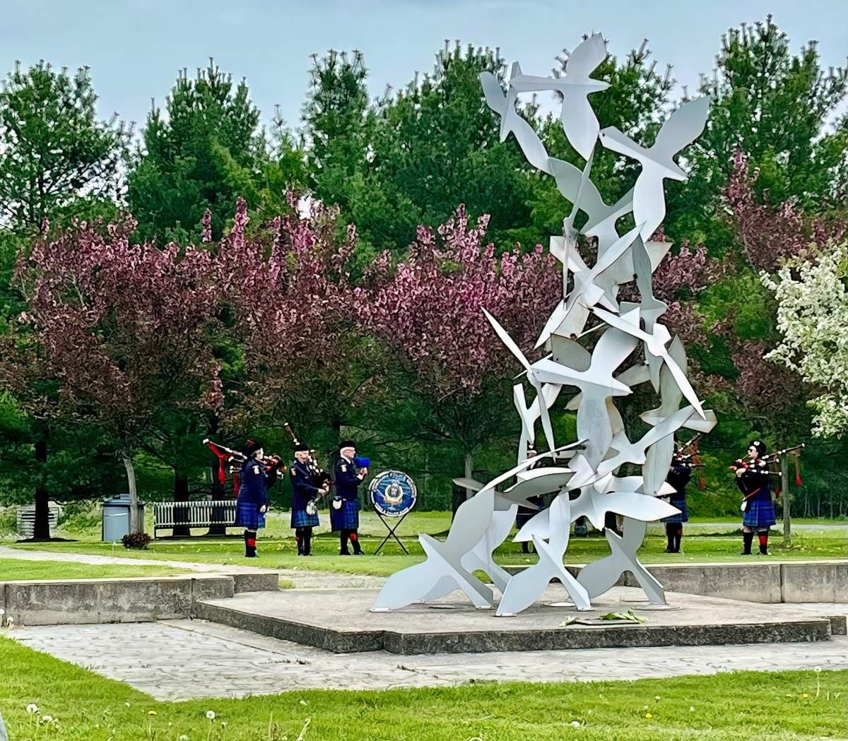 Bagpipers play during a ceremony for the 20th anniversary of the death of Const. Chris Garrett at the park named in his honour in Cobourg, Ont.