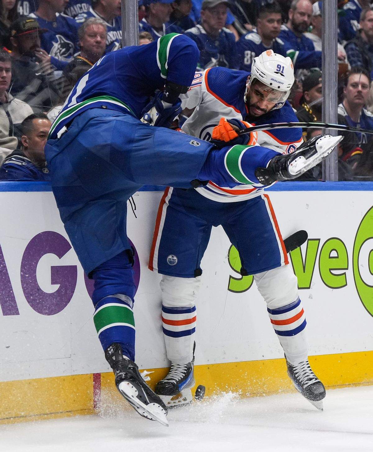 Edmonton Oilers' Evander Kane, back right, checks Vancouver Canucks' Nikita Zadorov during the second period in Game 7 of an NHL hockey Stanley Cup second-round playoff series, in Vancouver, on Monday, May 20, 2024.
