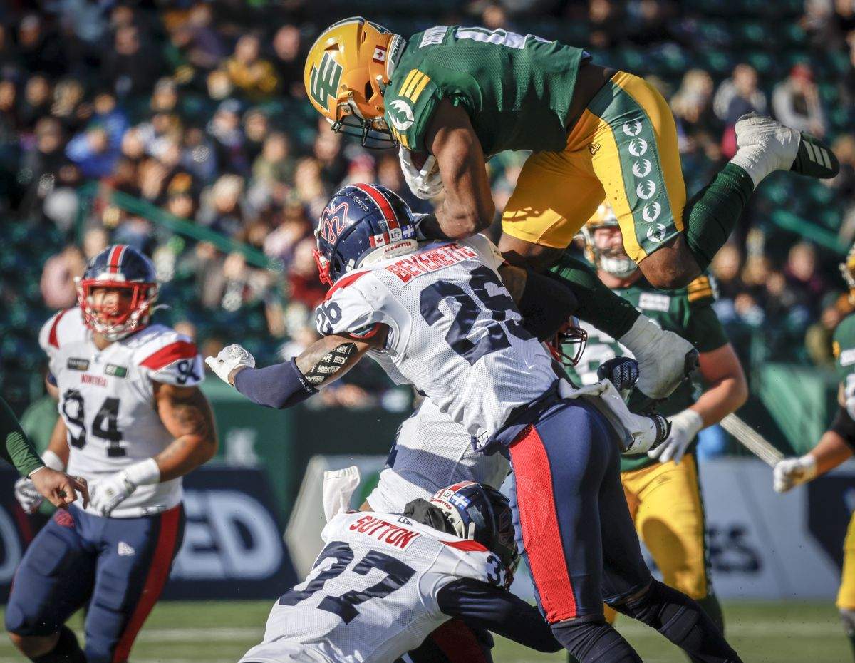 Montreal Alouettes defensive back Wesley Sutton, left, and linebacker Tyrice Beverette send Edmonton Elks running back Kevin Brown airborne during first half CFL football action in Edmonton, Saturday, Oct. 14, 2023.