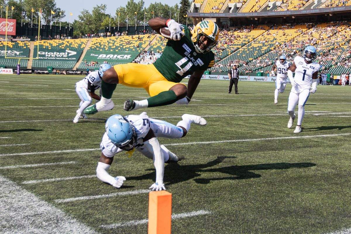 Toronto Argonauts Jamal Peters (3) misses the tackle as Edmonton Elks Kevin Brown (4) dives in for the touchdown during first half CFL action in Edmonton, Alta., on Sunday June 25, 2023.
