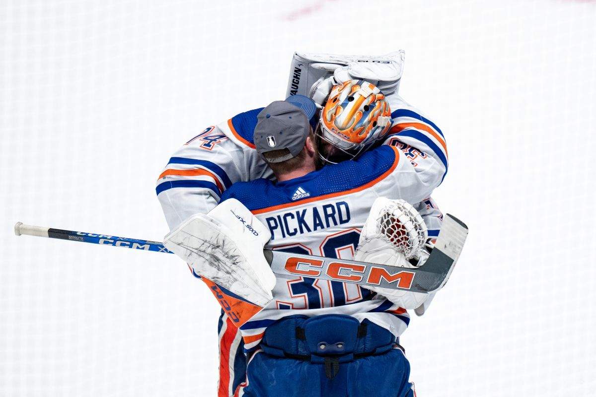 Edmonton Oilers' goalie Stuart Skinner (74), and goalie Calvin Pickard (30) celebrate after winning against the Vancouver Canucks in Game 7 of an NHL hockey Stanley Cup second-round playoff series, in Vancouver, on Monday, May 20, 2024.