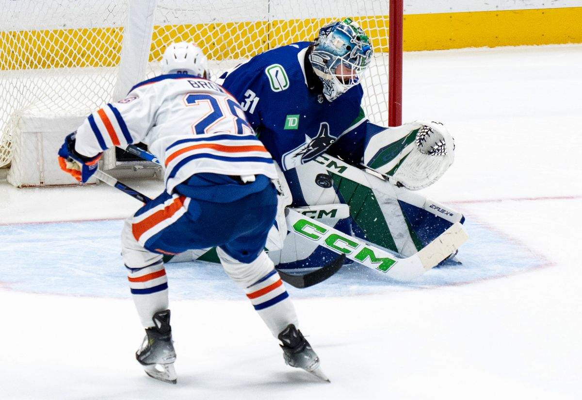 Vancouver Canucks goalie Arturs Silovs stops Edmonton Oilers' Connor Brown during the first period in Game 7 of an NHL hockey Stanley Cup second-round playoff series, in Vancouver, on Monday, May 20, 2024.