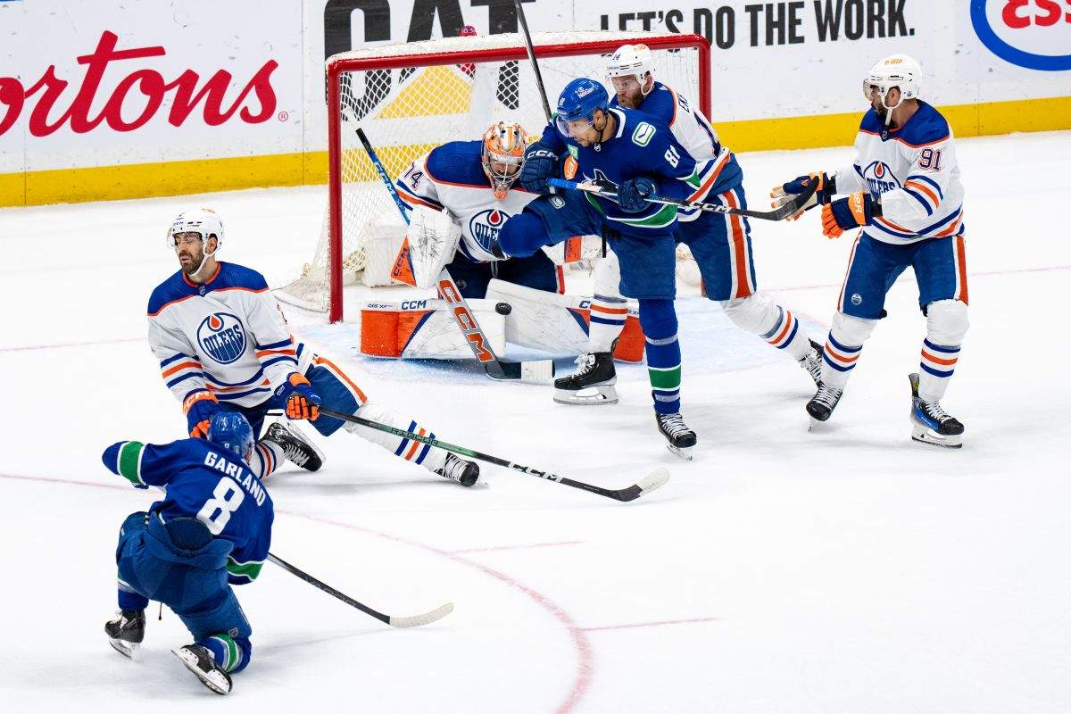 Edmonton Oilers goalie Stuart Skinner (74) stops Vancouver Canucks' Conor Garland's shot, as Evan Bouchard (2), Mattias Ekholm (14), Evander Kane (91), and Vancouver's Dakota Joshua (81) watches during the second period in Game 7 of an NHL hockey Stanley Cup second-round playoff series, in Vancouver, on Monday, May 20, 2024.