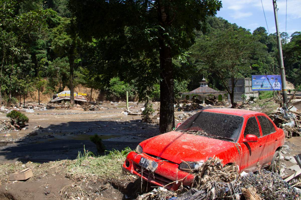 The wreckage of a car lies in a village affected by a flash flood in Tanah Datar, West Sumatra, Indonesia, Sunday, May 12, 2024. (AP Photo/Fachri Hamzah)