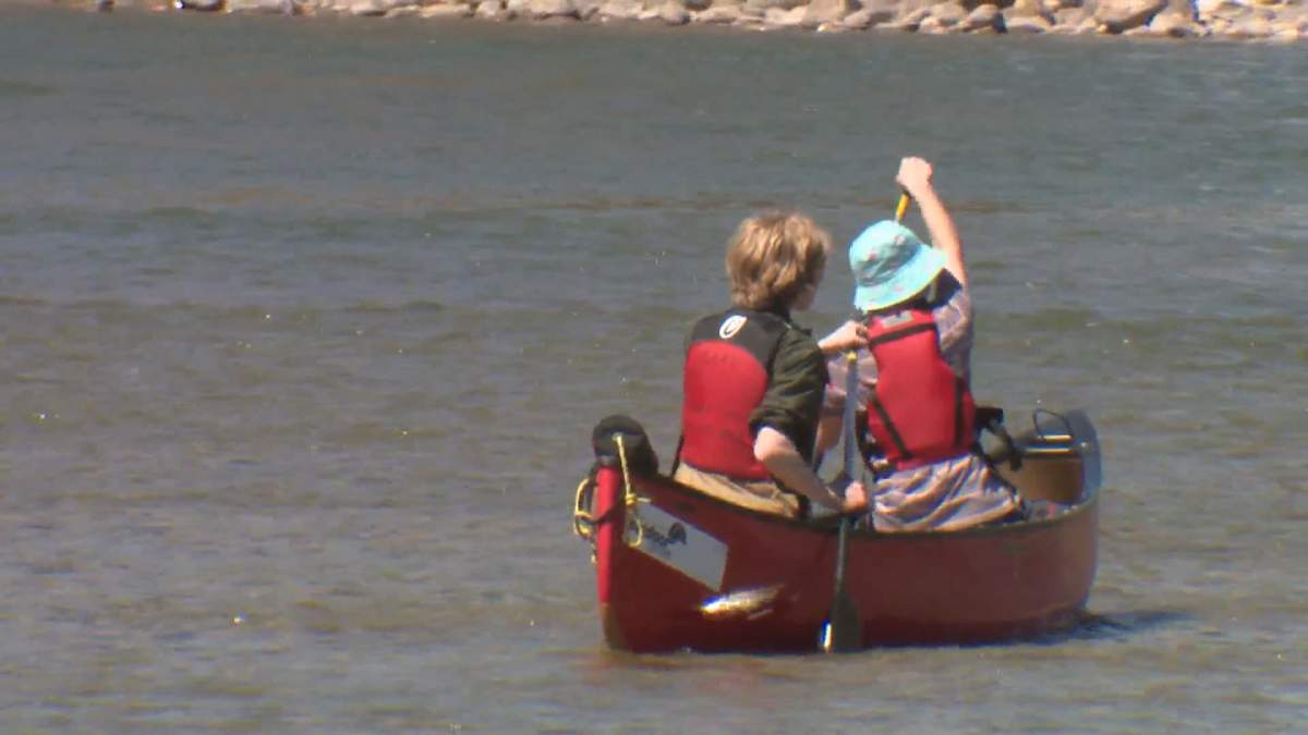 Canoeists on the Bow River in Calgary, taking advantage of the unseasonably warm weather to start this Mother's Day weekend.