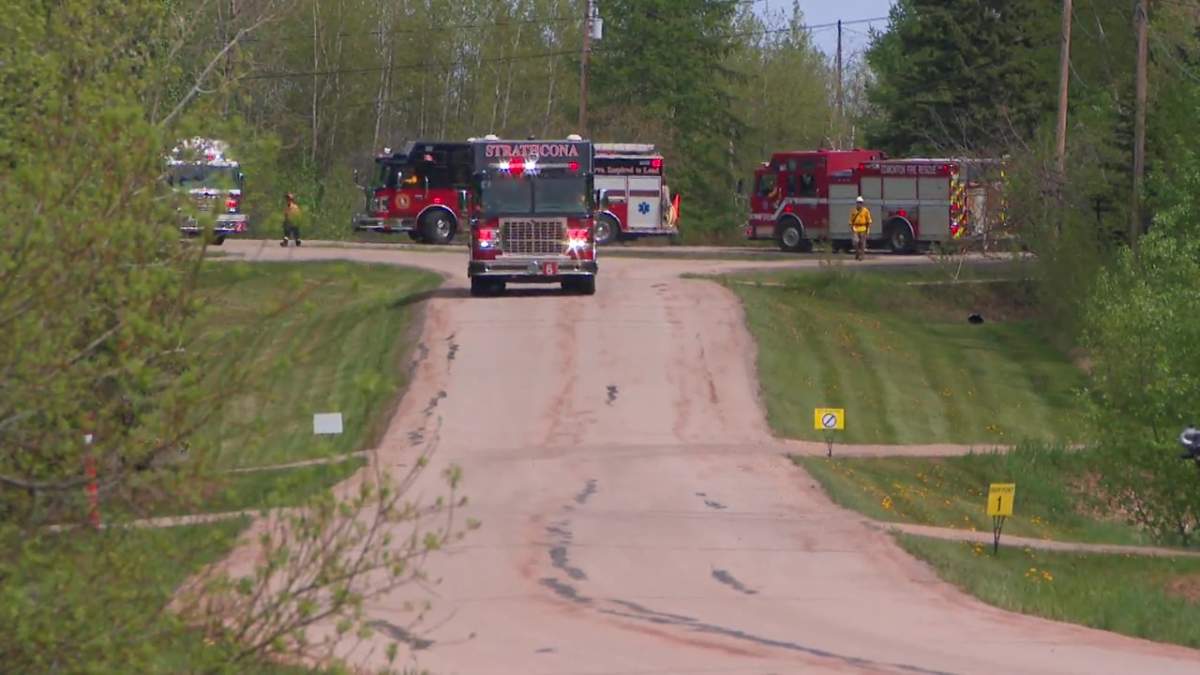 Firefighters from across Canada taking part in a International Association of Fire Fighters urban wildfire training exercise and mock fire simulation in Strathcona County, Alta. on Tuesday, May 28, 2024.