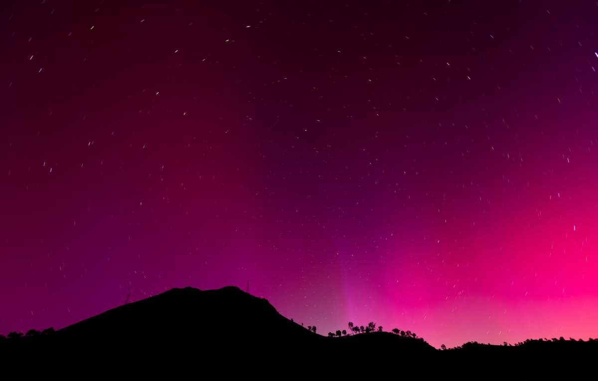 The aurora borealis, also known as the northern lights, is visible over Lake Berryessa, Calif., early Saturday, May 11, 2024. (Carlos Avila Gonzalez/San Francisco Chronicle via AP)