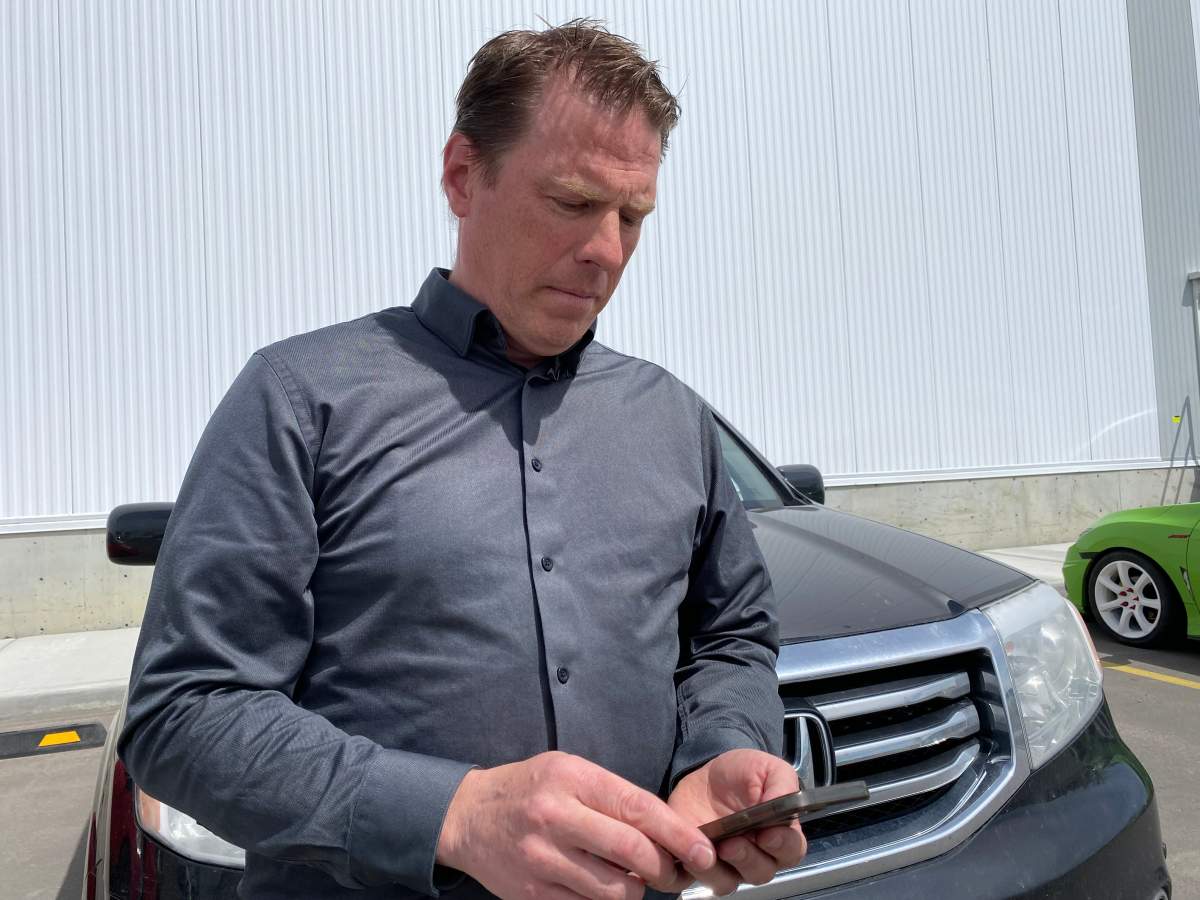 Tony Ferris looking at his parking ticket