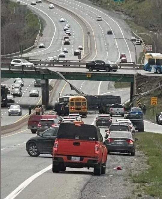 A tractor-trailer tipped over an overpass on Highway 102 near Lower Sackville last Thursday and nearly collided with a bus full of students. Credit: Talk Bedford/Facebook