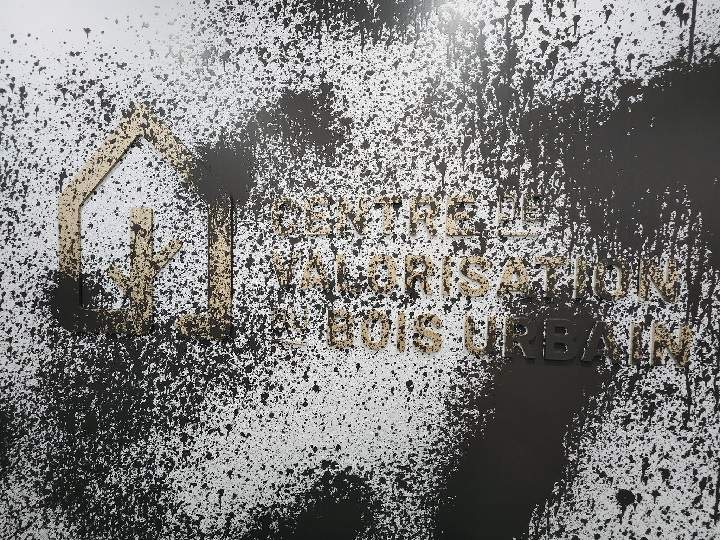 Brown paint splattered on a wall.