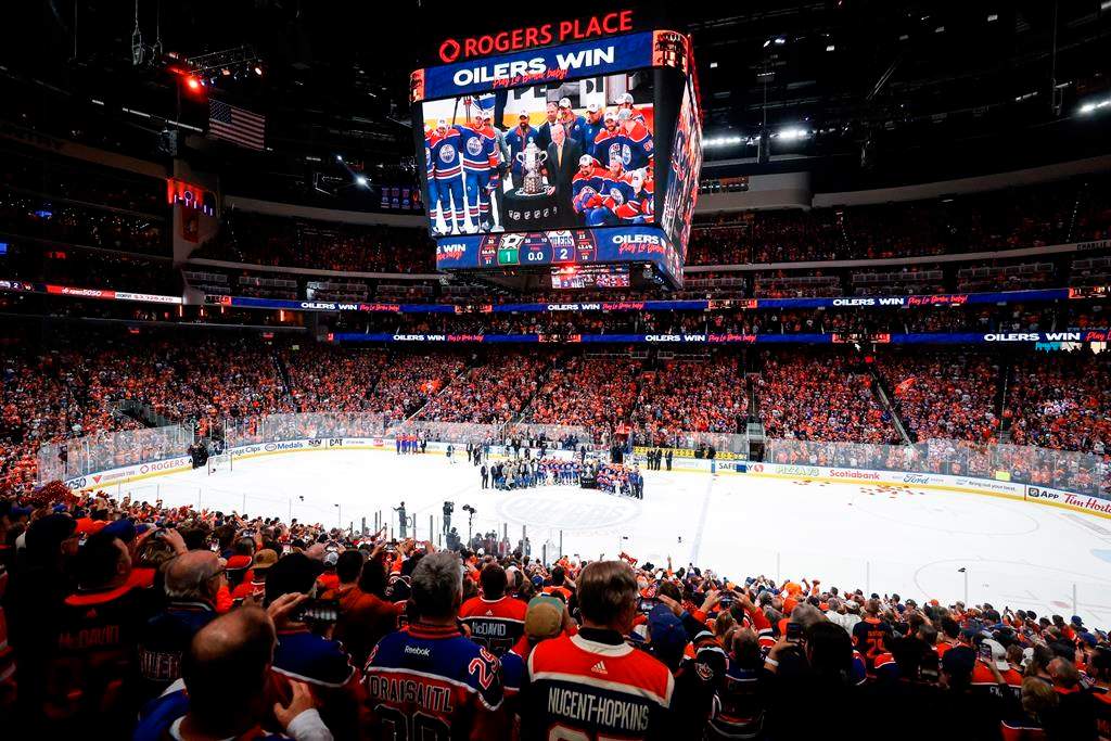 The Edmonton Oilers pose with the trophy after defeating the Dallas Stars in Game 6 of the Western Conference finals of the NHL hockey Stanley Cup playoffs in Edmonton, Sunday, June 2, 2024.