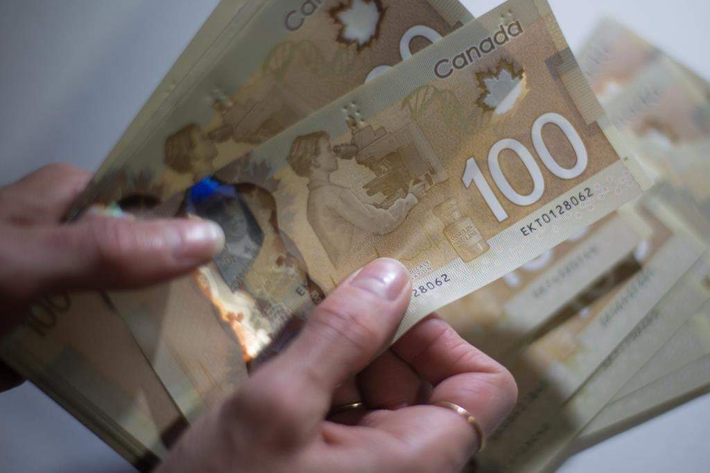 Canadian $100 bills are counted in Toronto, Feb. 2, 2016.