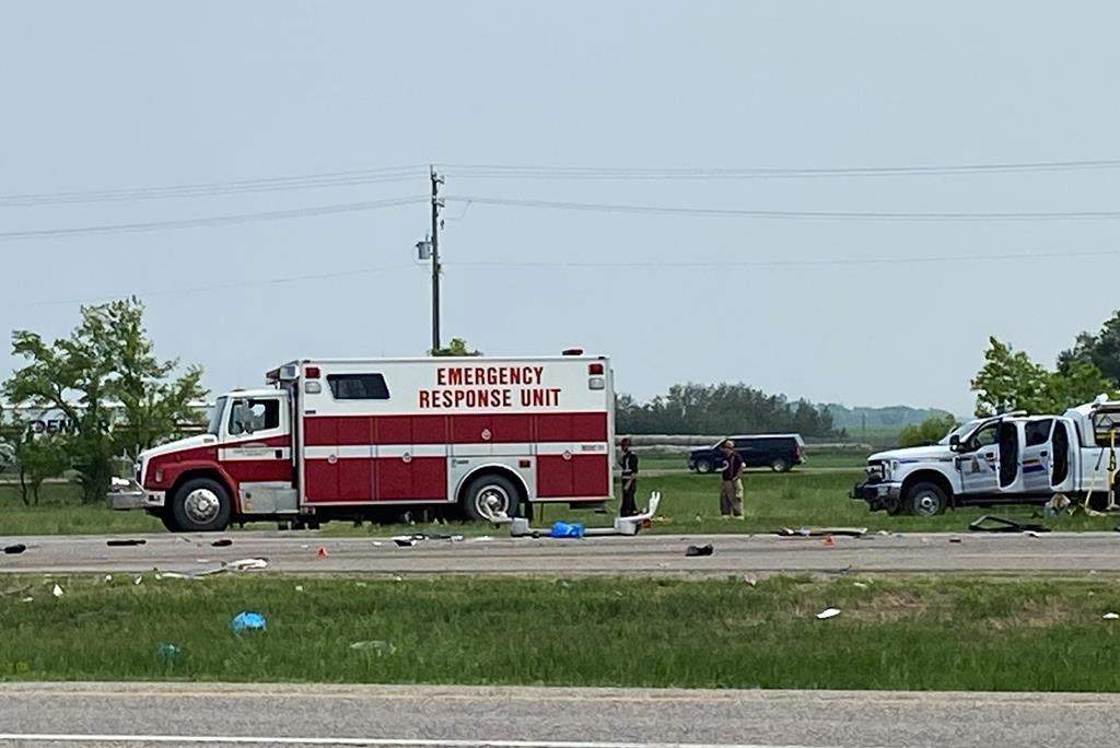 Emergency crews respond to the scene that closed a section of the Trans-Canada Highway near Carberry, Man., on Thursday, June 15, 2023. The year that has passed since the crash killed 17 seniors headed to a casino has been one of grief, community support, a slow return to normal and, for some, a long road to recovery. THE CANADIAN PRESS/Steve Lambert.