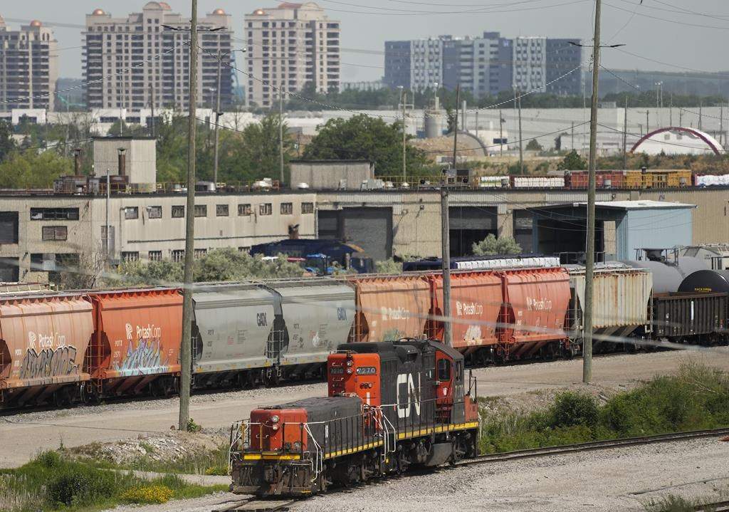 Quebec travellers who were hoping to hit New York City by train this summer will now have to wait until fall. CN rail trains are shown at the CN MacMillan Yard in Vaughan, Ont., on Monday, June 20, 2022. THE CANADIAN PRESS/Nathan Denette.