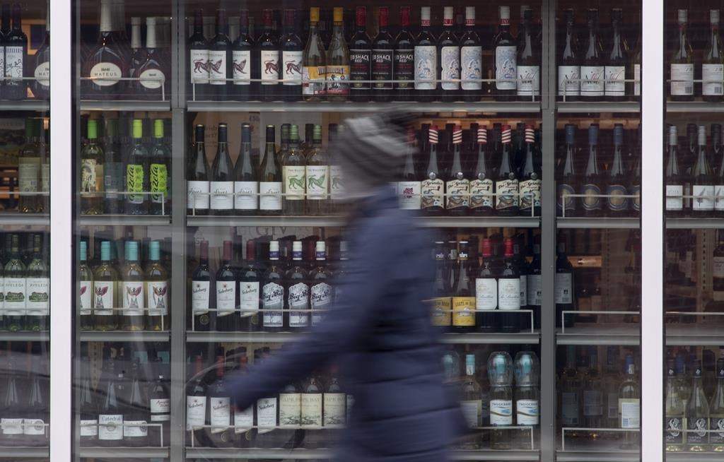 Workers at Ontario’s main liquor retailer have set a date to strike. A person walks past shelves of bottles of alcohol on display at an LCBO in Ottawa, Thursday March 19, 2020.