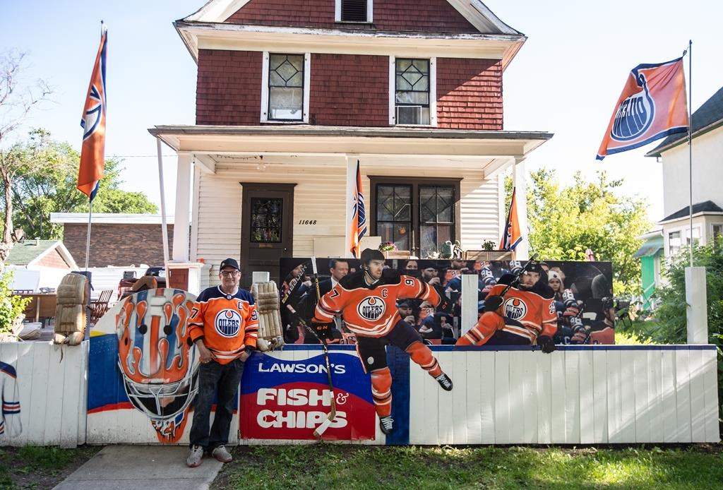 Oilers fan Warren Sillanpaa shows support for his favourite team after decorating his house in Edmonton on Thursday June 20, 2024.