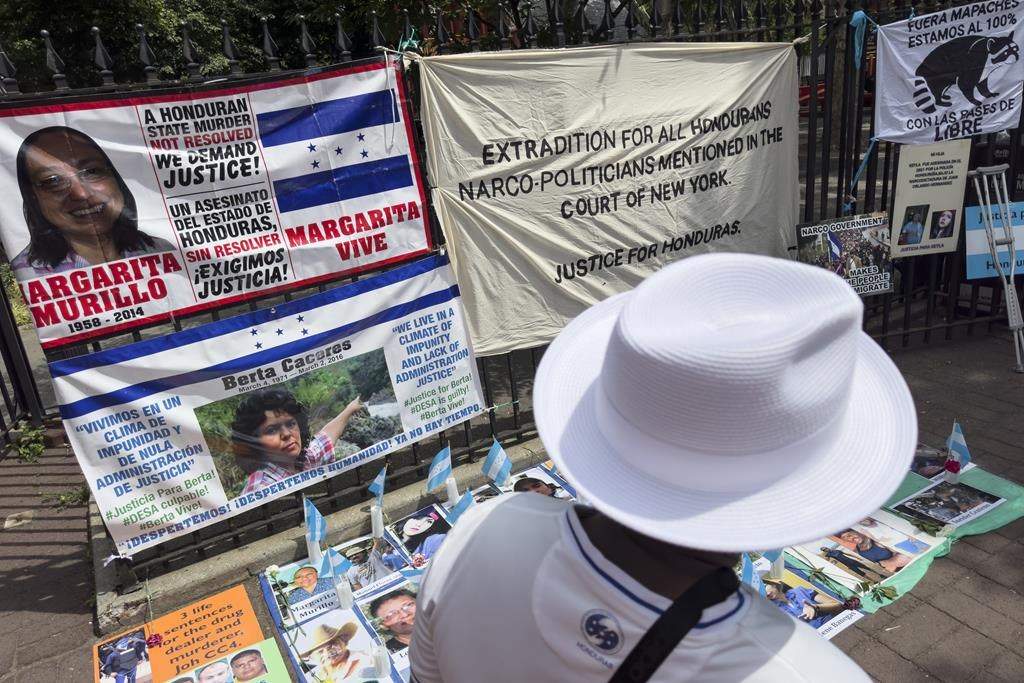 Protestors’ signs and images of victims of Honduran drug traffickers outside Federal court, Wednesday, June 26, 2024, in New York. Former Honduran President Juan Orlando Hernandez was sentenced to 45 years in prison after being convicted in New York of conspiring with drug traffickers, his military and police to enable tons of cocaine to reach the United States. (AP Photo/John Minchillo)