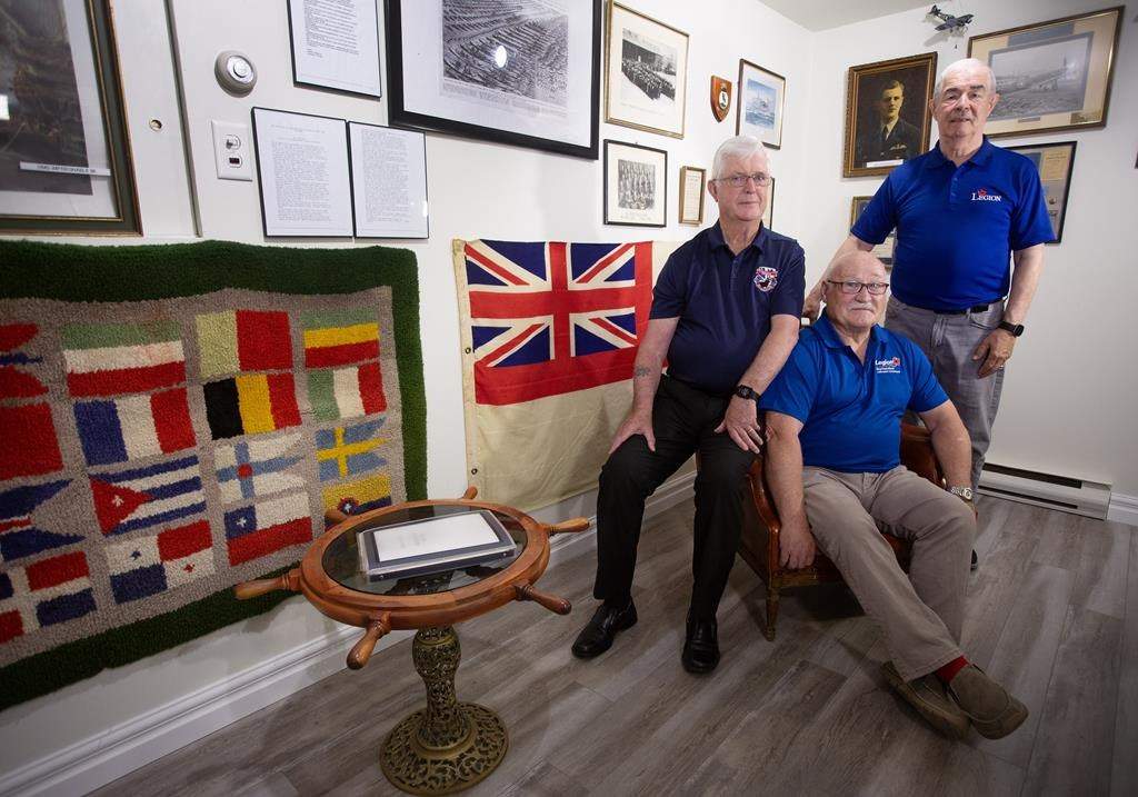 Berkley Lawrence (centre), along with Frank Sullivan (left) and Gary Browne, legion members who helped bring the remains of an unknown Newfoundland soldier home, pose for a picture at the Legion Branch 56 in St. John's on Tuesday, June 25, 2024.