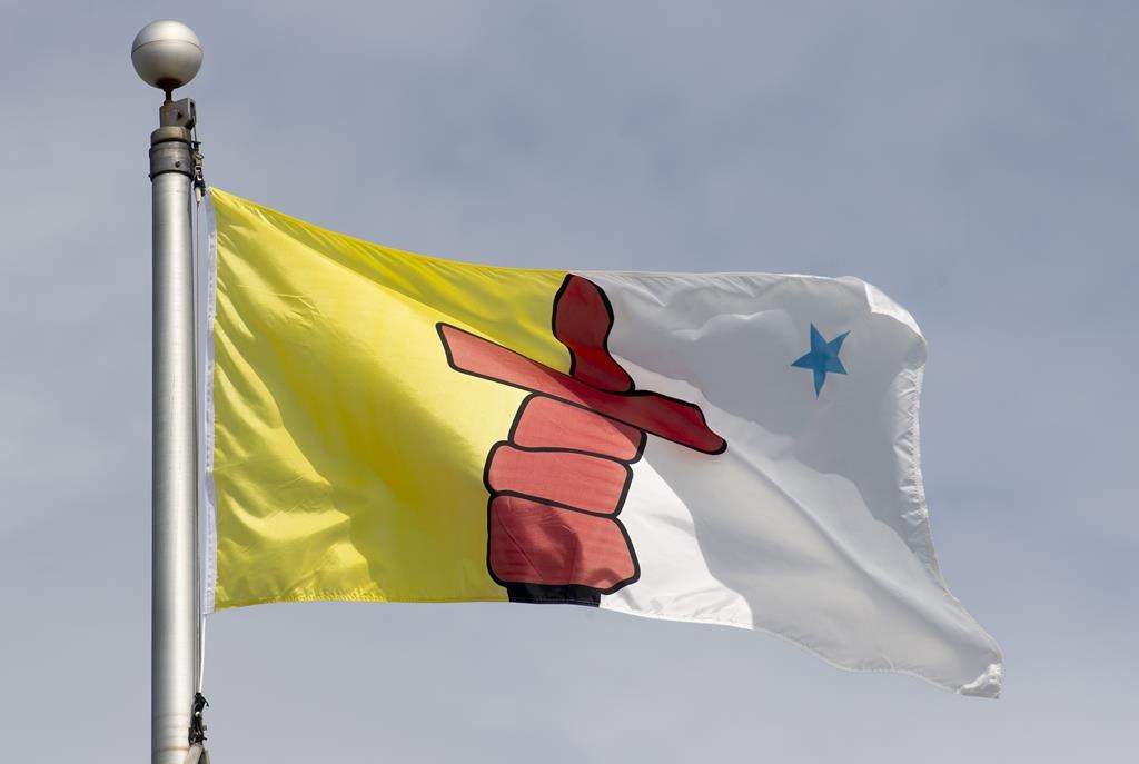 A Nunavut judge has sentenced a Toronto woman to three years in prison in a case of Inuit identity fraud. Nunavut's territorial flag flies in Ottawa, Tuesday June 30, 2020. 