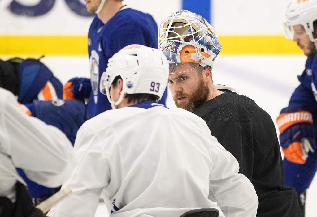 Calvin Pickard (30) chats with Ryan Nugent-Hopkins (93) during an Oilers practice before taking on the Florida Panthers in the NHL Stanley Cup playoffs, in Edmonton, Wednesday, June 5, 2024.