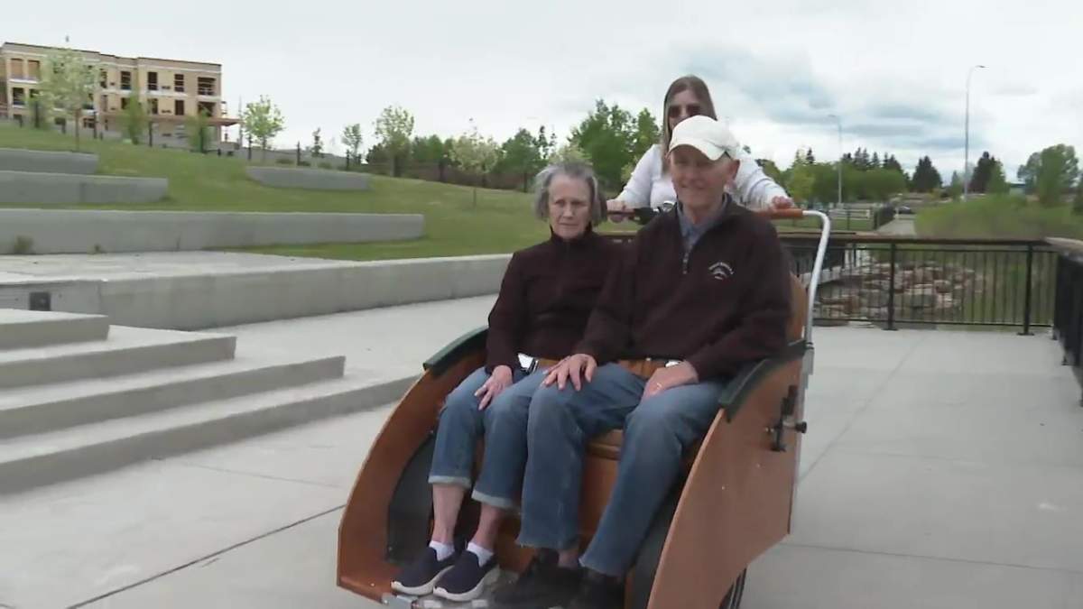 Mike and Bev Pannett enjoying the ride while Cambridge Manor's Morgan Poppy pilots the trishaw bike.