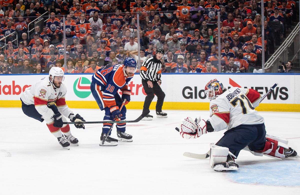 Florida Panthers' goalie Sergei Bobrovsky (72) makes the save on Edmonton Oilers' Zach Hyman (18) as Dmitry Kulikov (7) defends during second period Game 3 action of the NHL Stanley Cup final in Edmonton on Thursday, June 13, 2024.