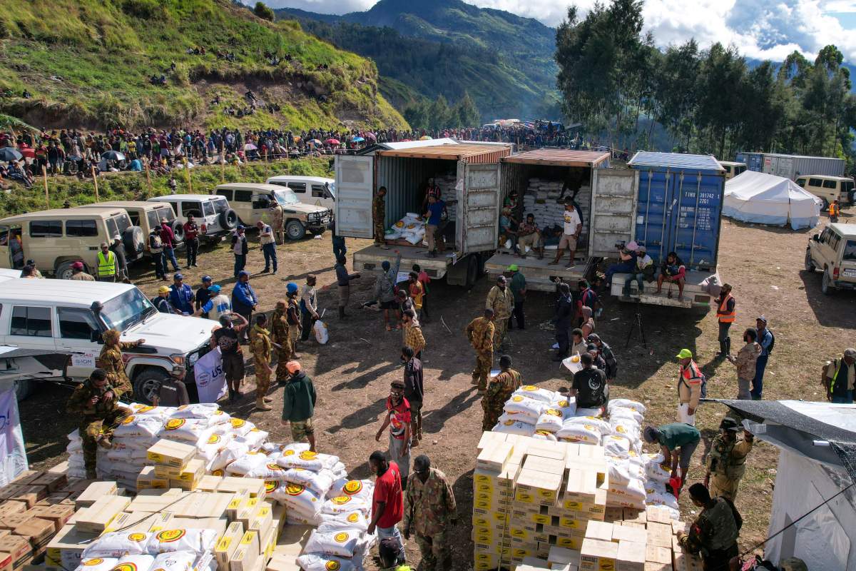 Villagers wait as food aid is distributed at a temporary site for the displaced, following the May 24 landslide near Yambali village in the highlands of Papua New Guinea, Monday, June 3, 2024. (Juho Valta/UNDP Papua New Guinea)