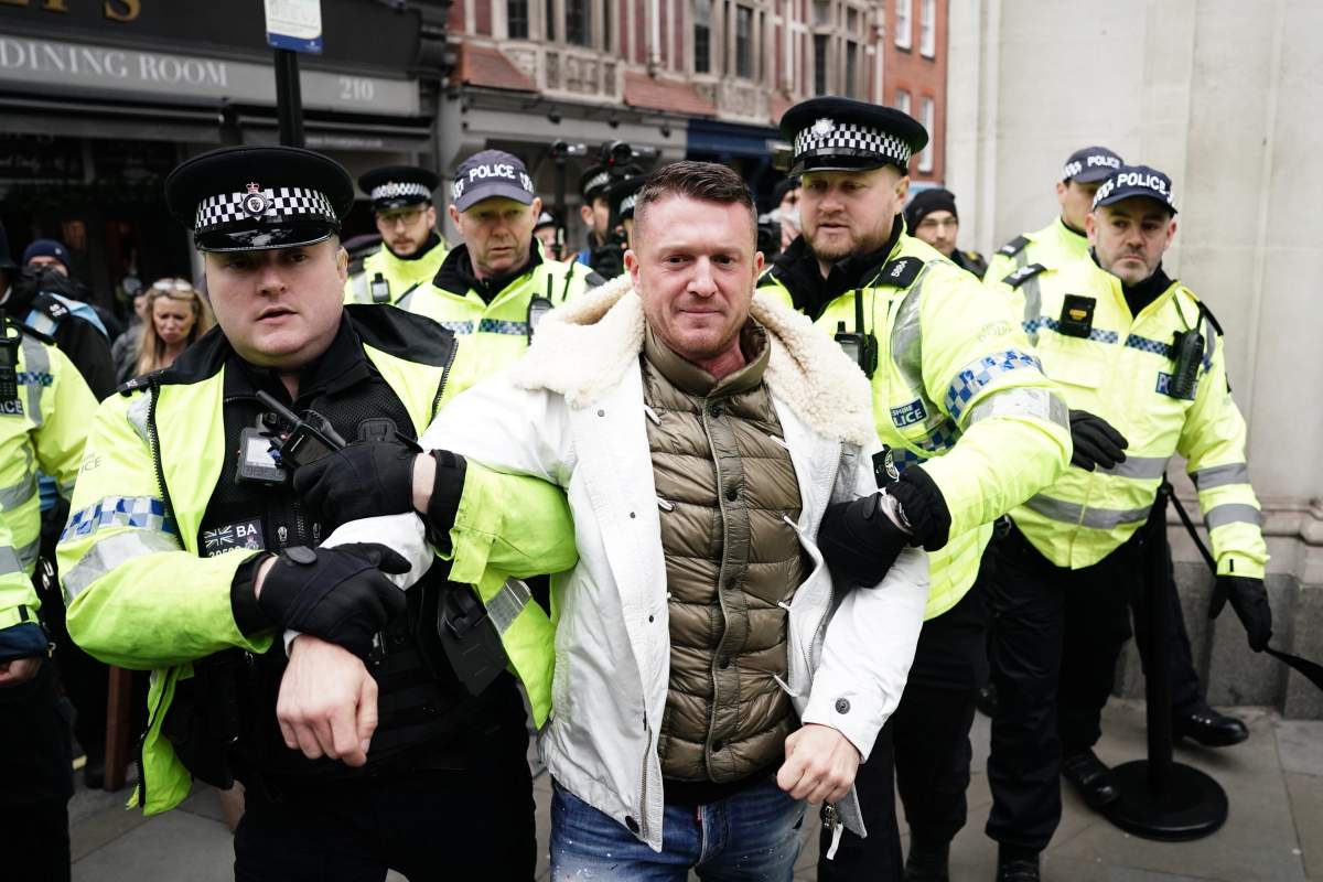 Tommy Robinson is led away by police officers as people take part in a march against antisemitism organised by the volunteer-led charity Campaign Against Antisemitism at the Royal Courts of Justice in London. Picture date: Sunday November 26, 2023.