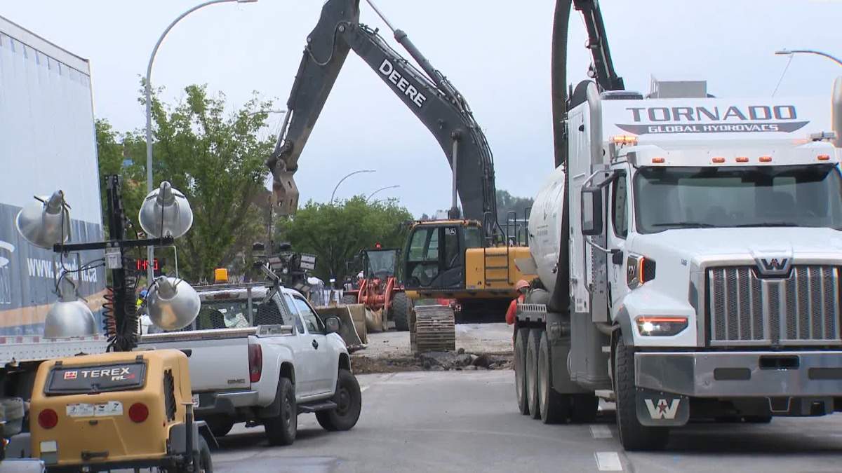 Crews work on water main repairs in northwest Calgary on June 17, 2024.