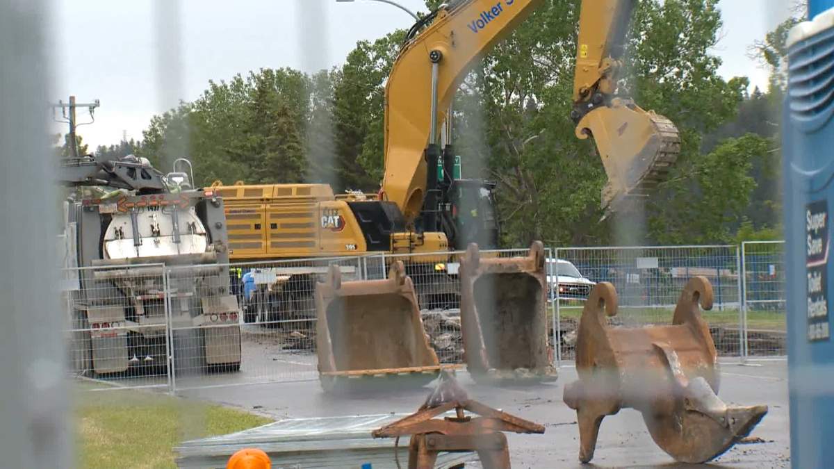 Crews work on water main repairs in northwest Calgary on June 17, 2024.