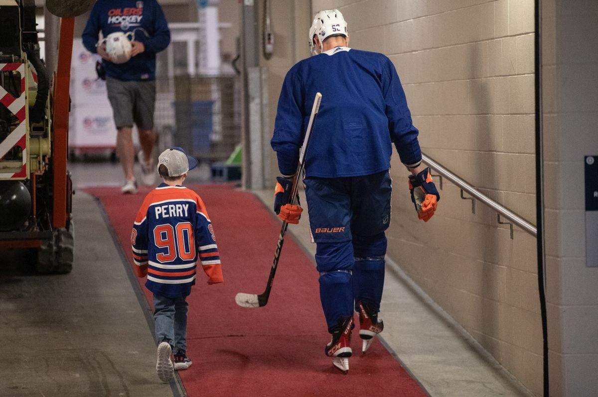 Edmonton Oilers' Corey Perry (90) and his son Griffen walk together after practice before the Oilers take on the Florida Panthers in the NHL Stanley Cup playoffs, in Edmonton, Wednesday, June 5, 2024.