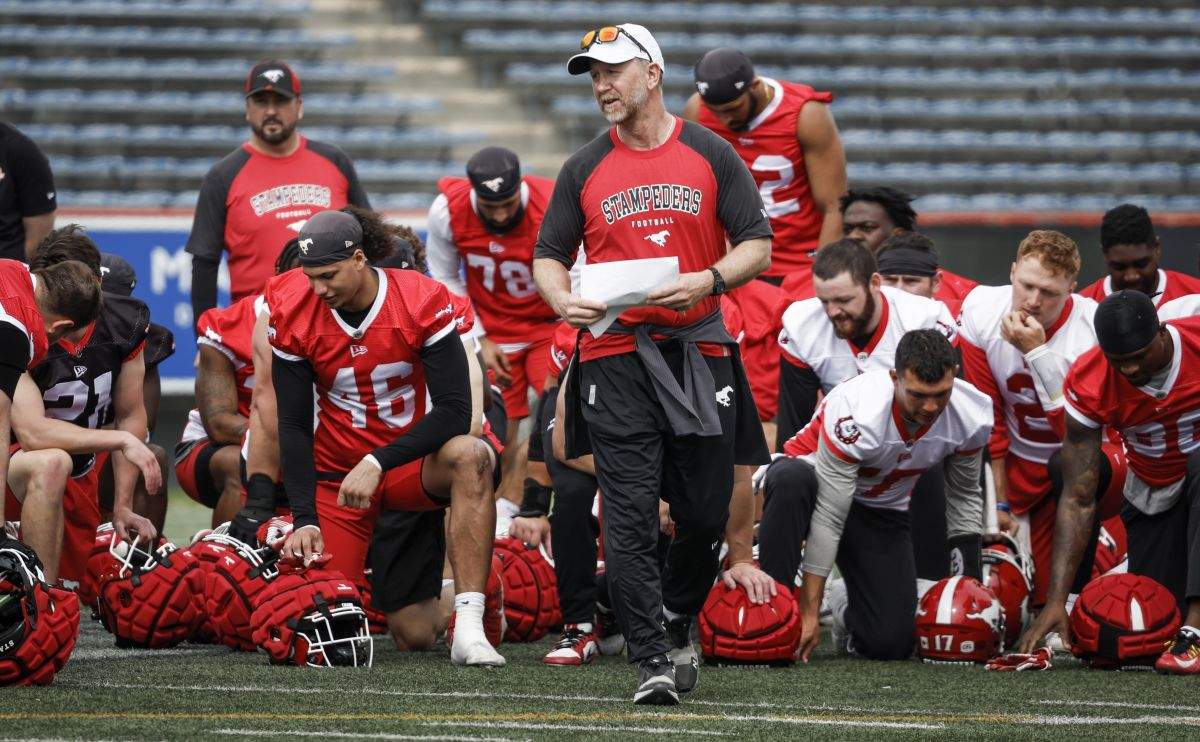 Calgary Stampeders head coach Dave Dickenson, centre right, speaks to players during opening day of training camp in Calgary, Alta., Sunday, May 12, 2024.