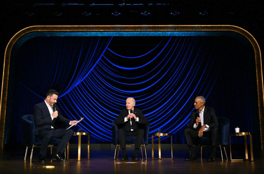 U.S. President Joe Biden (C) speaks, flanked by television host Jimmy Kimmel (L) and former President Barack Obama, onstage during a campaign fundraiser at the Peacock Theater in Los Angeles on June 15, 2024.