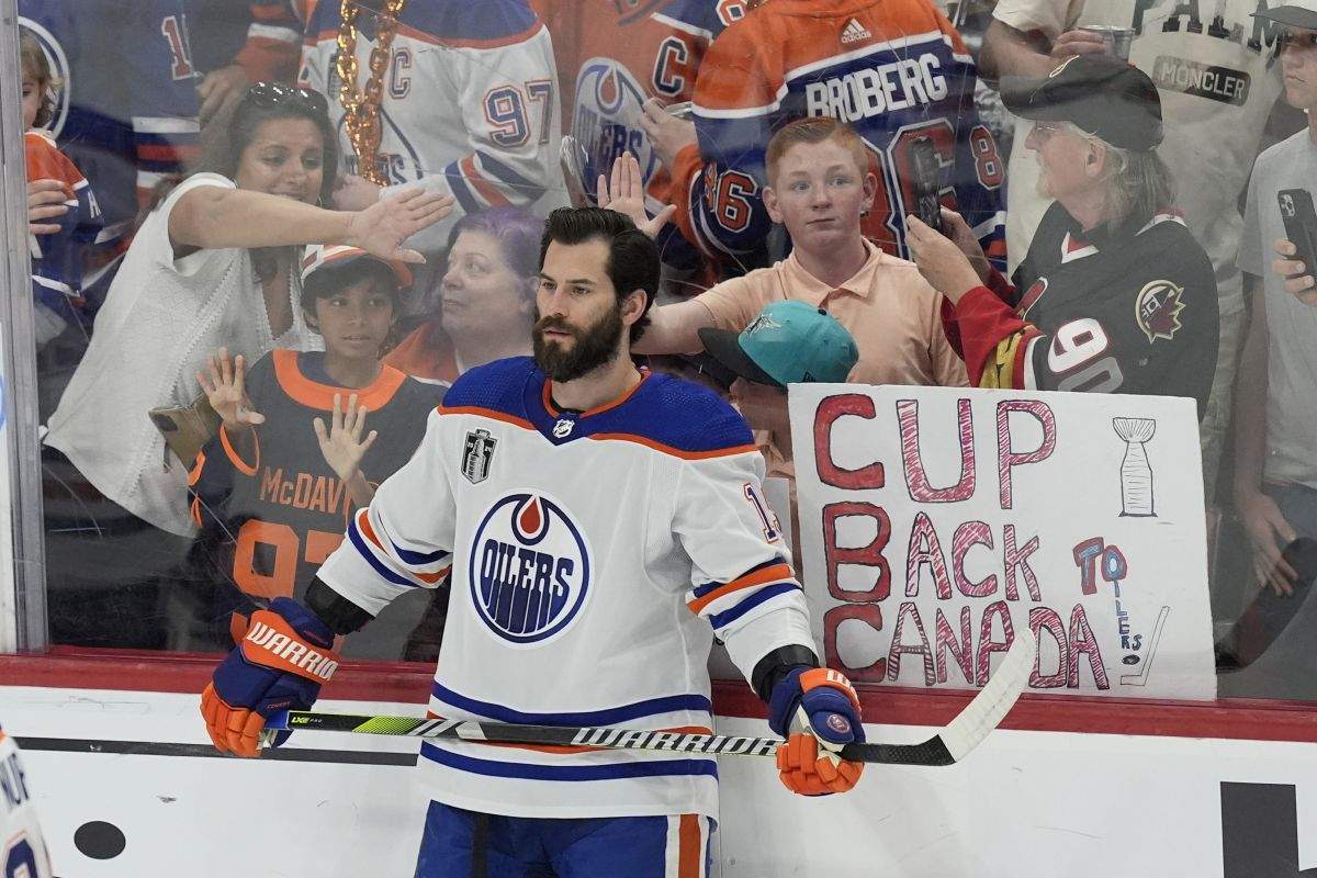 Fans try to get the attention of Edmonton Oilers center Adam Henrique before Game 7 of the NHL hockey Stanley Cup Final against the Florida Panthers, Monday, June 24, 2024, in Sunrise, Fla.